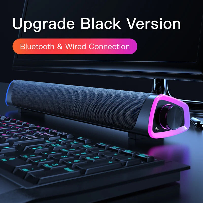 Computer speaker bar on a desk, featuring Bluetooth and wired connection text.
